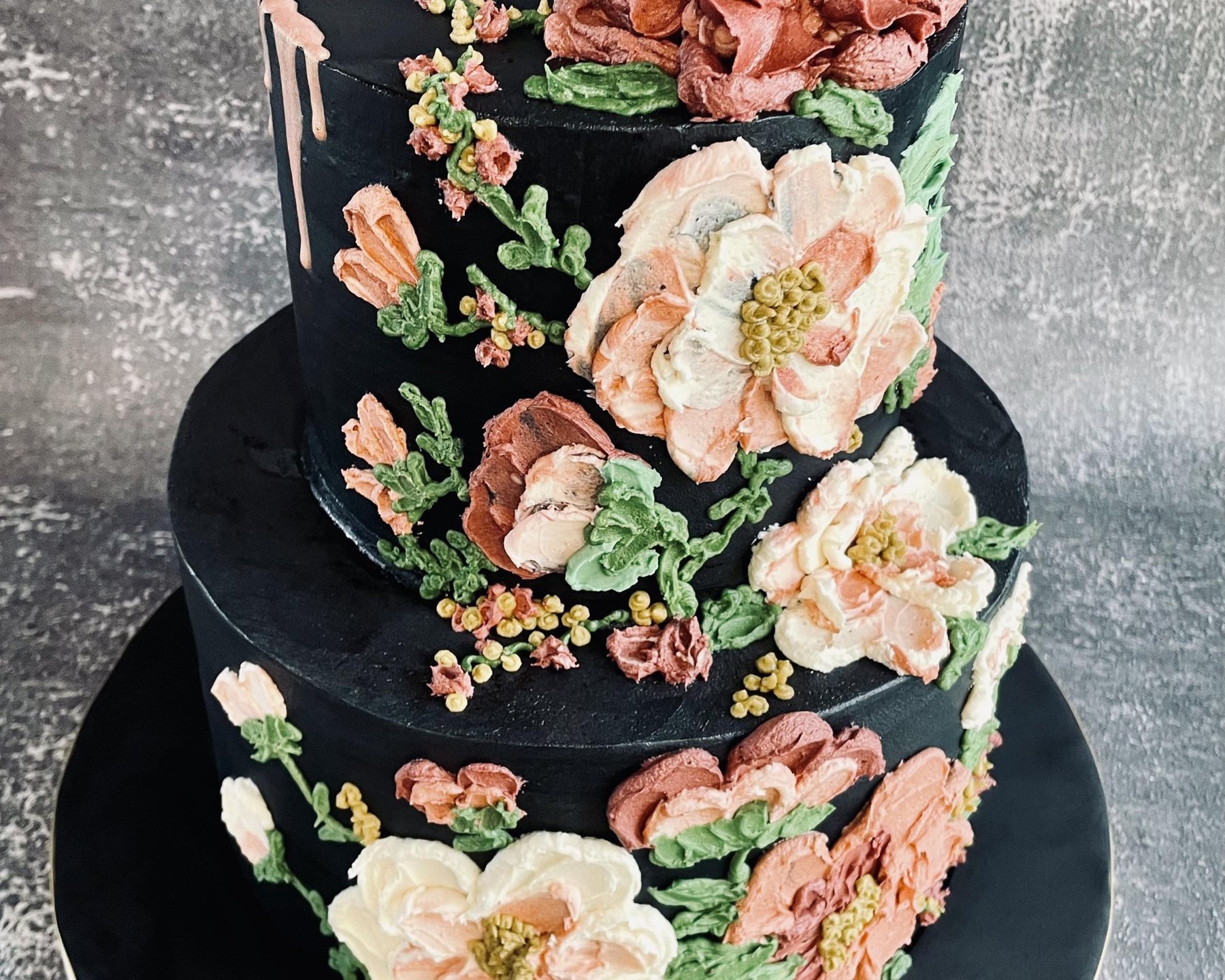 Black cake with painted buttercream flowers